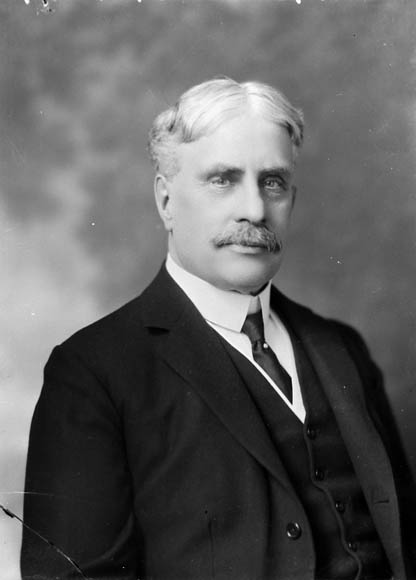 a black and white pograph of a man with a mustache