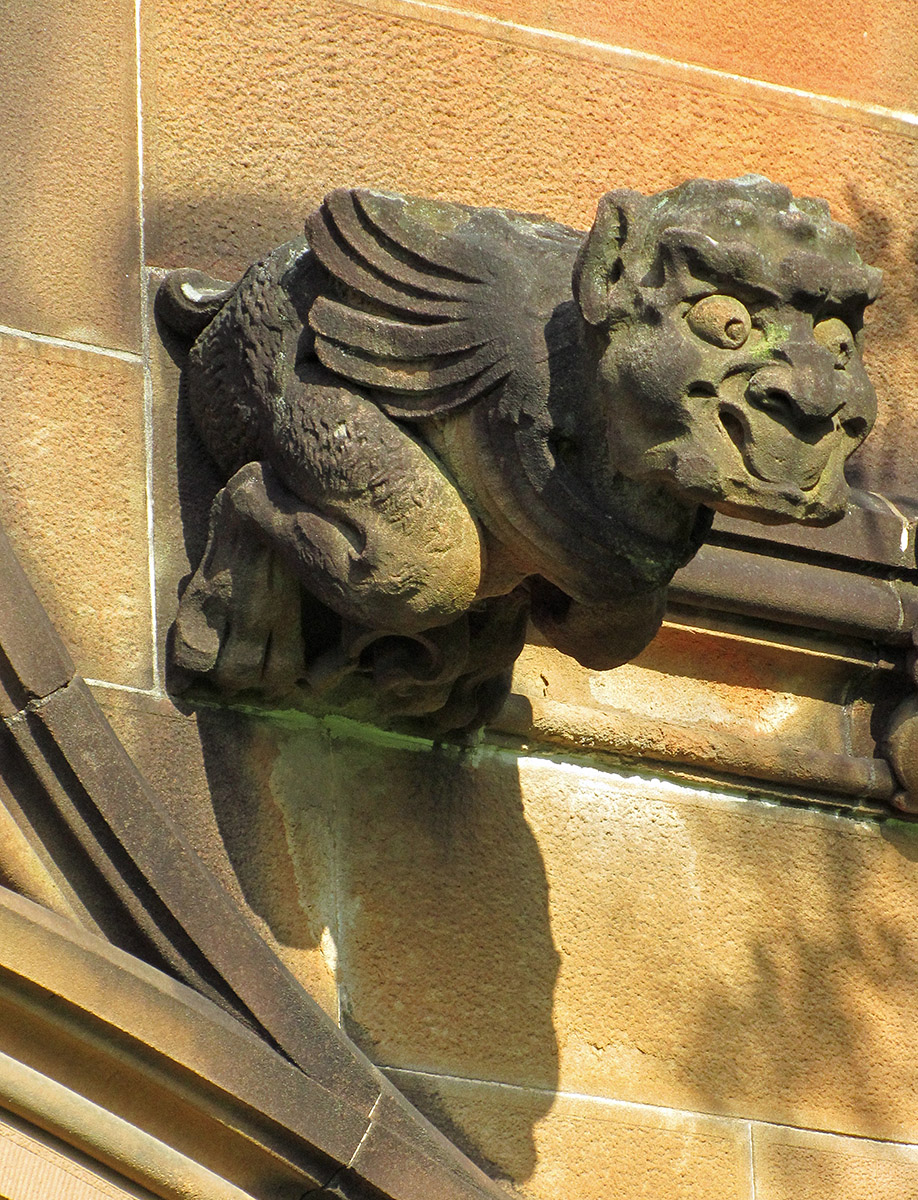 gargoyle decoration attached to the side of a wall