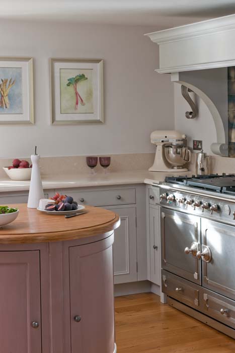 a kitchen scene with focus on the oven and an island