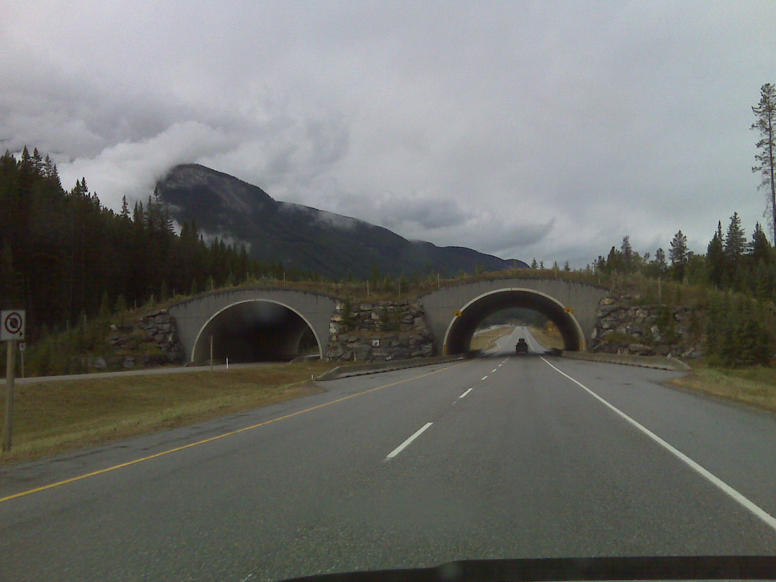a large tunnel sitting on the side of a road