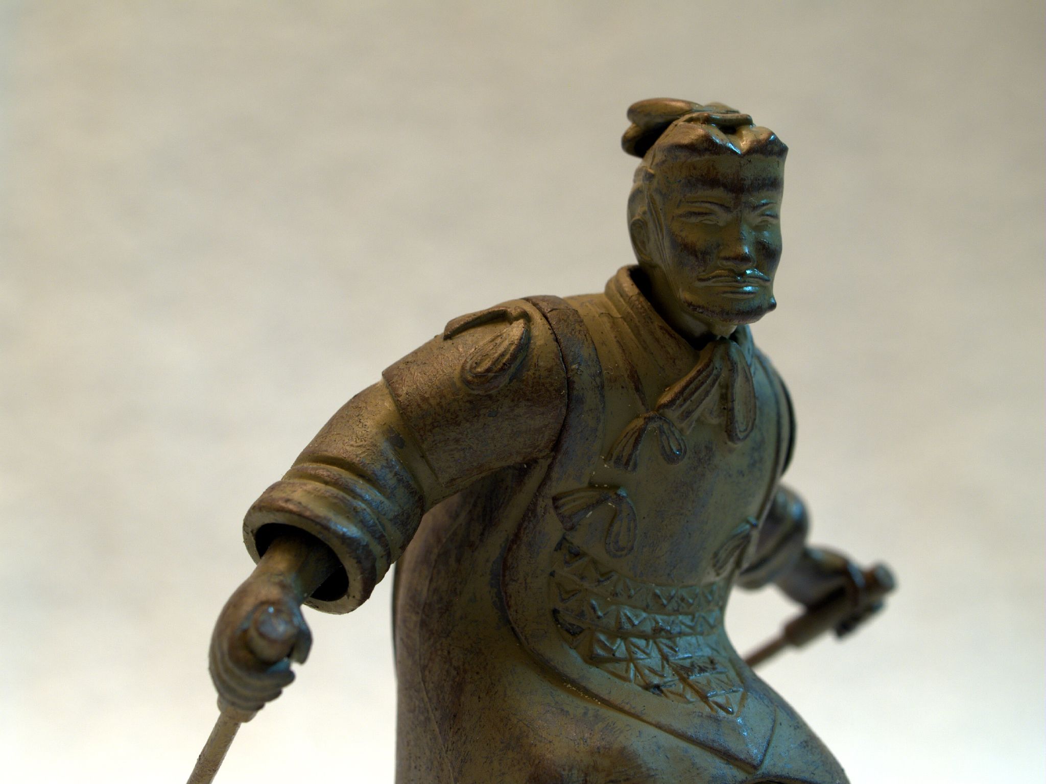 a small statue of a man holding a sword