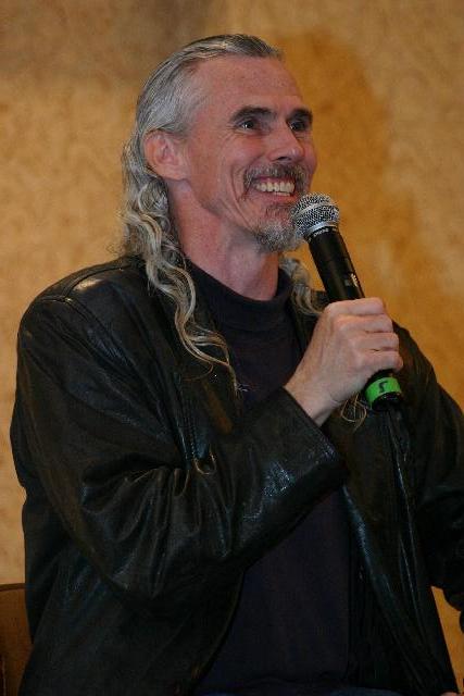 a man singing into a microphone in a room