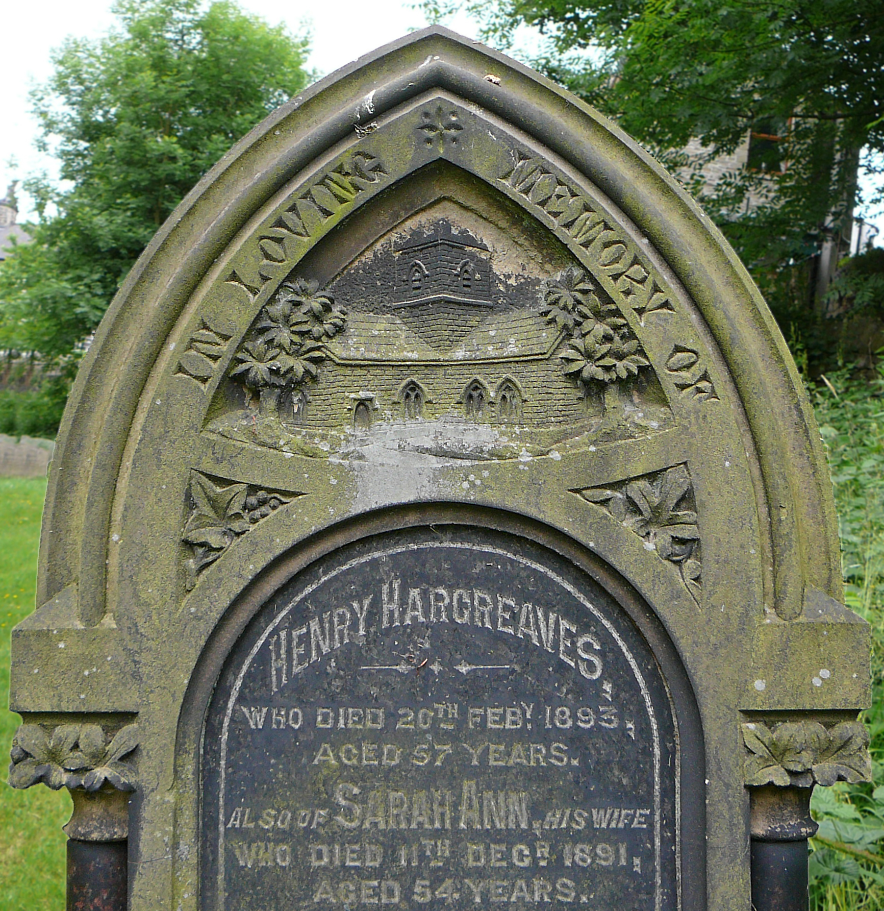 the headstone of a stone grave in a cemetery