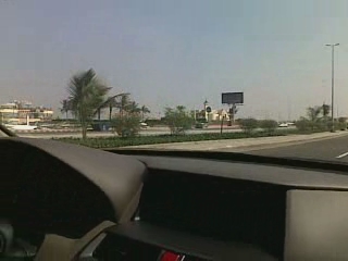 a person driving a car with the dashboard down
