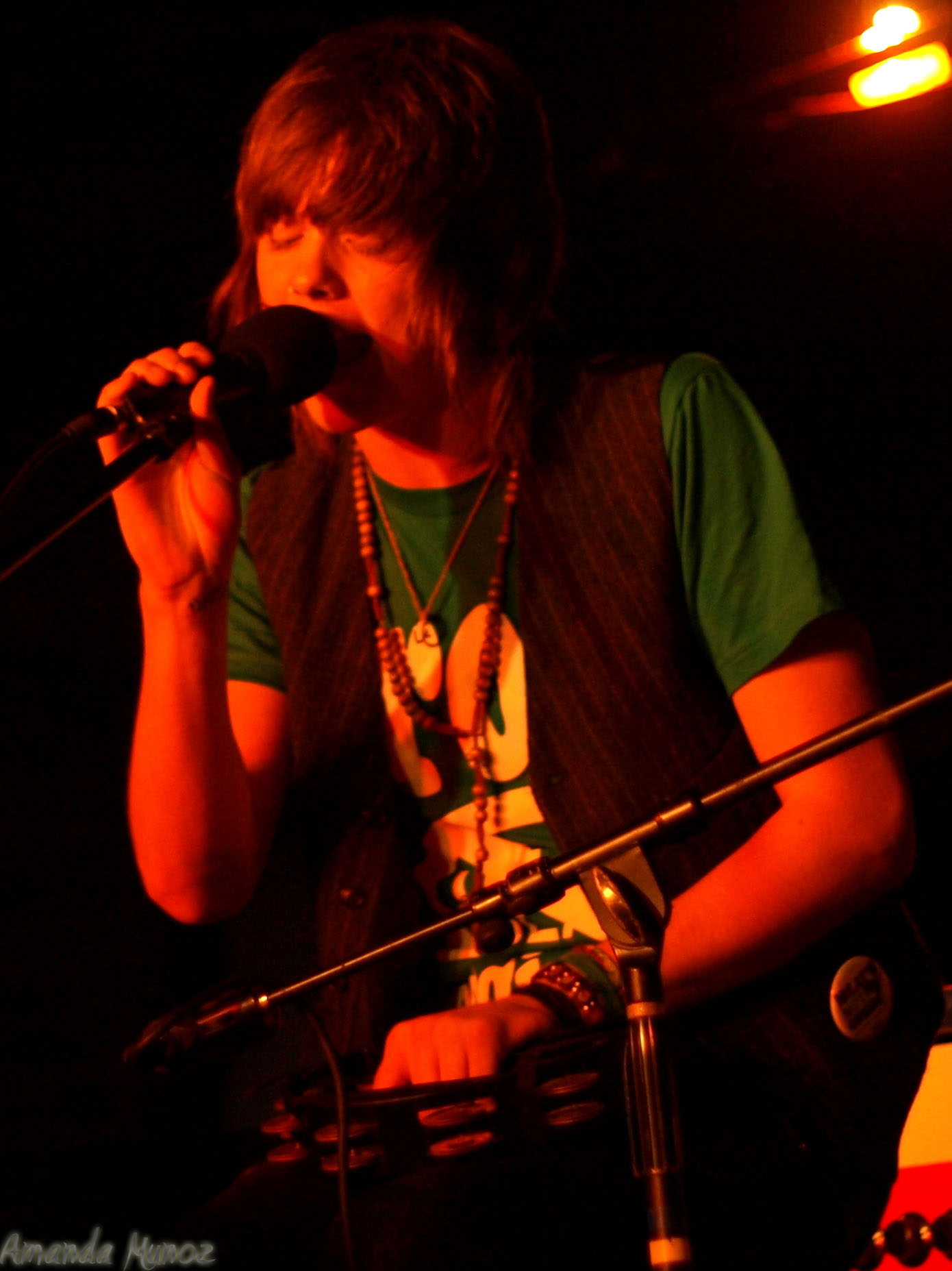 a man singing in front of a microphone