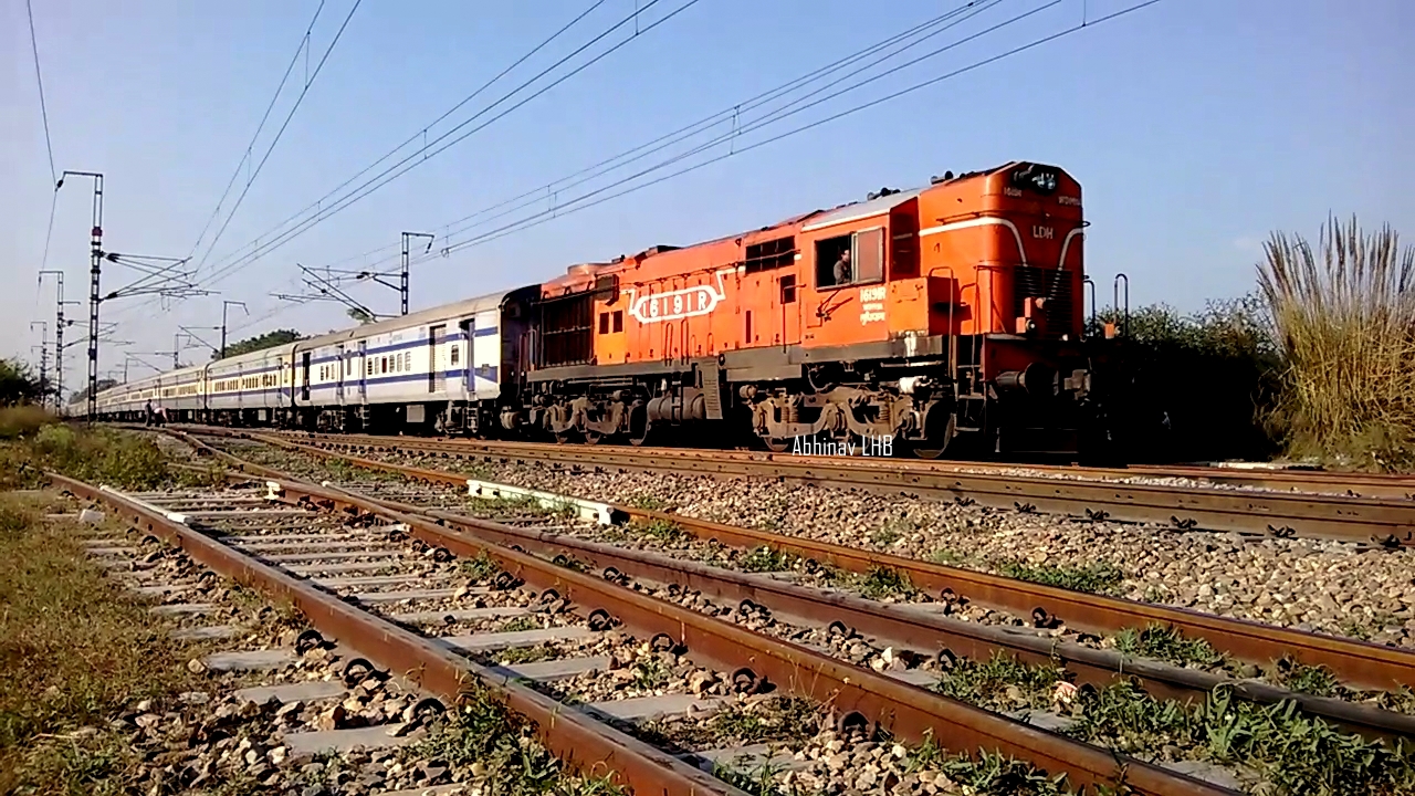 the locomotive car is orange and white