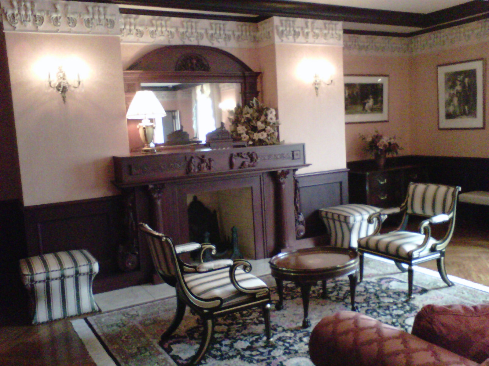 a large living room with chairs and a couch