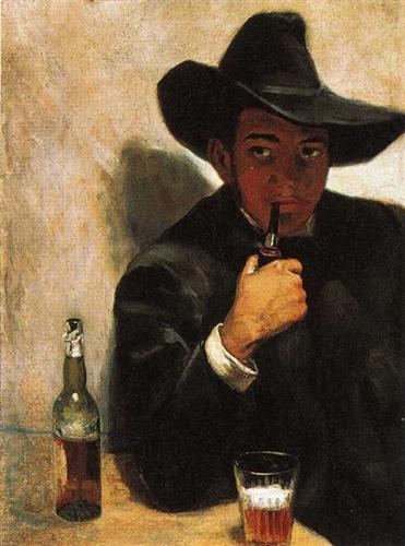 a man in black sitting at a table with a bottle and glass