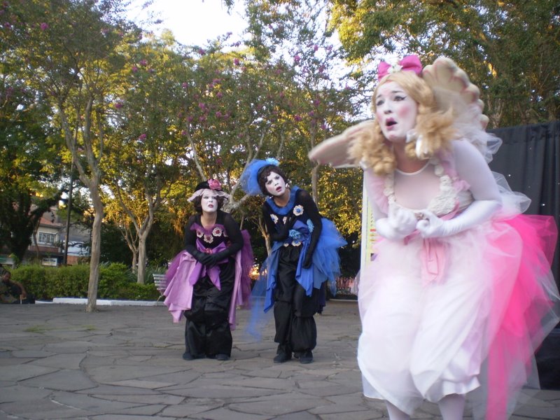 group of people in costume walking in street next to fence