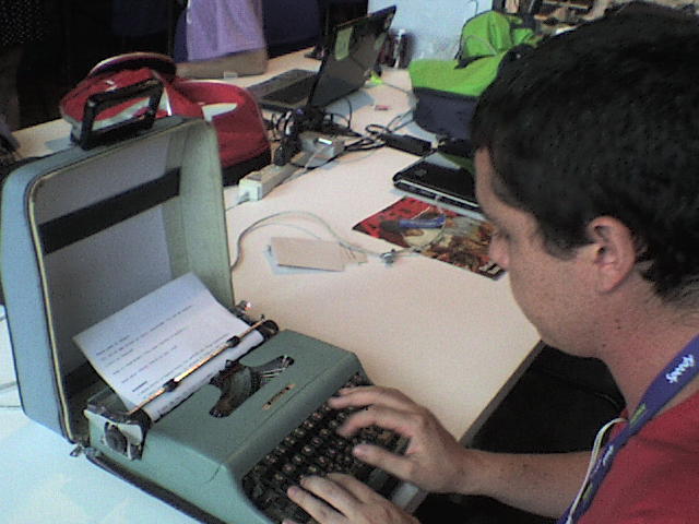 a young man using a laptop computer in an open suitcase