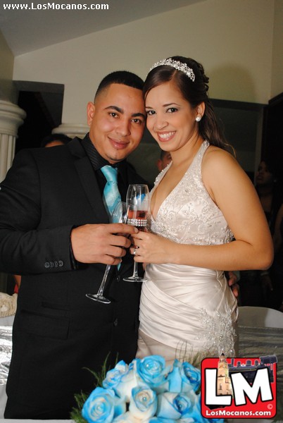 two people standing near one another holding up champagne glasses