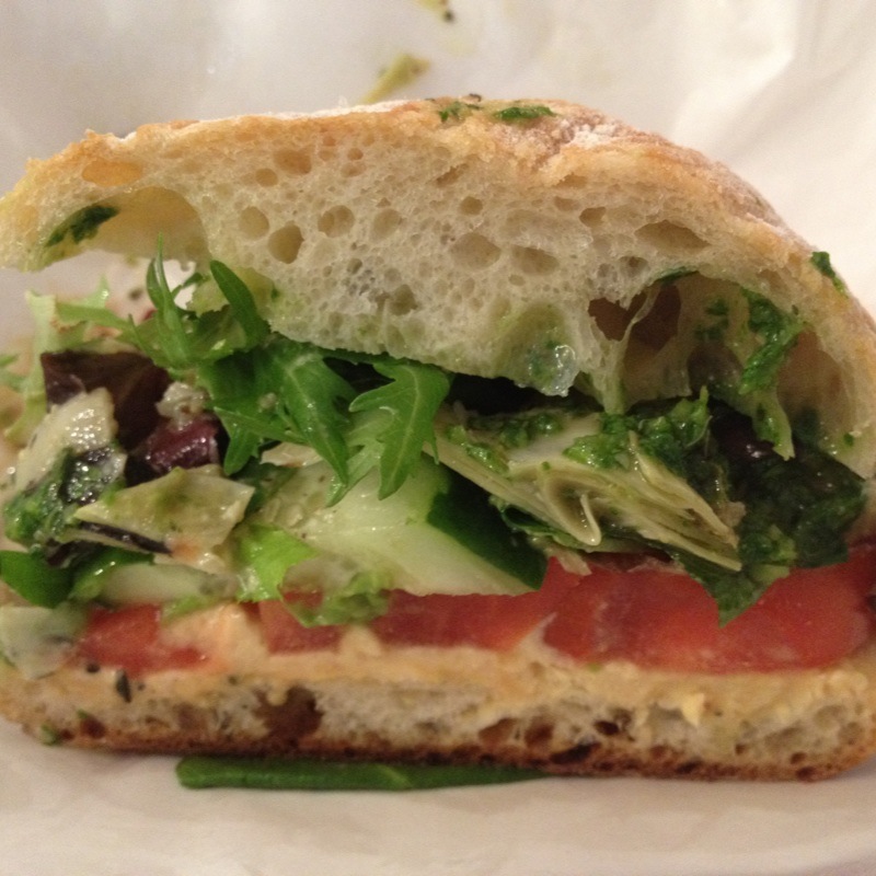 a sandwich with many vegetables and other food items on it