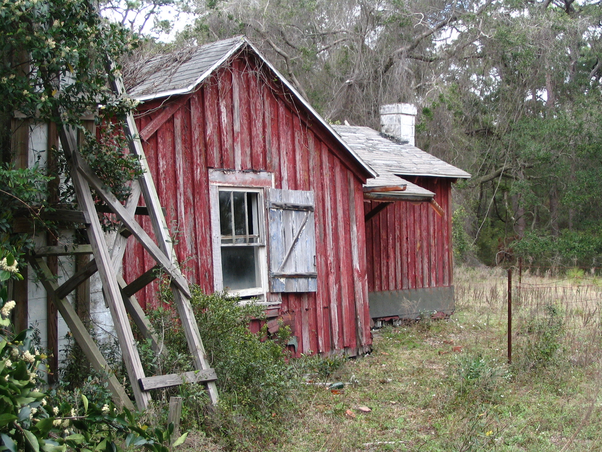 an old wooden barn sits in the field