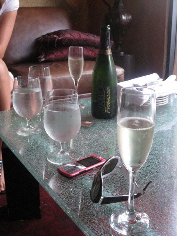 some wine glasses and a bottle sitting on a table