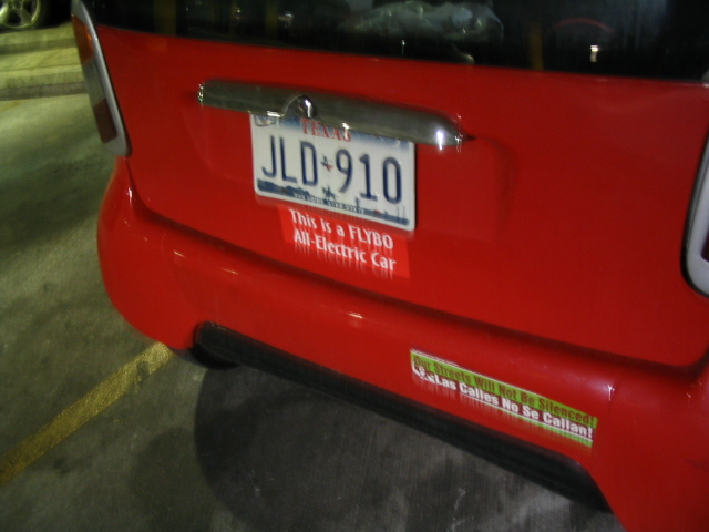 a closeup of a red vehicle with a license plate