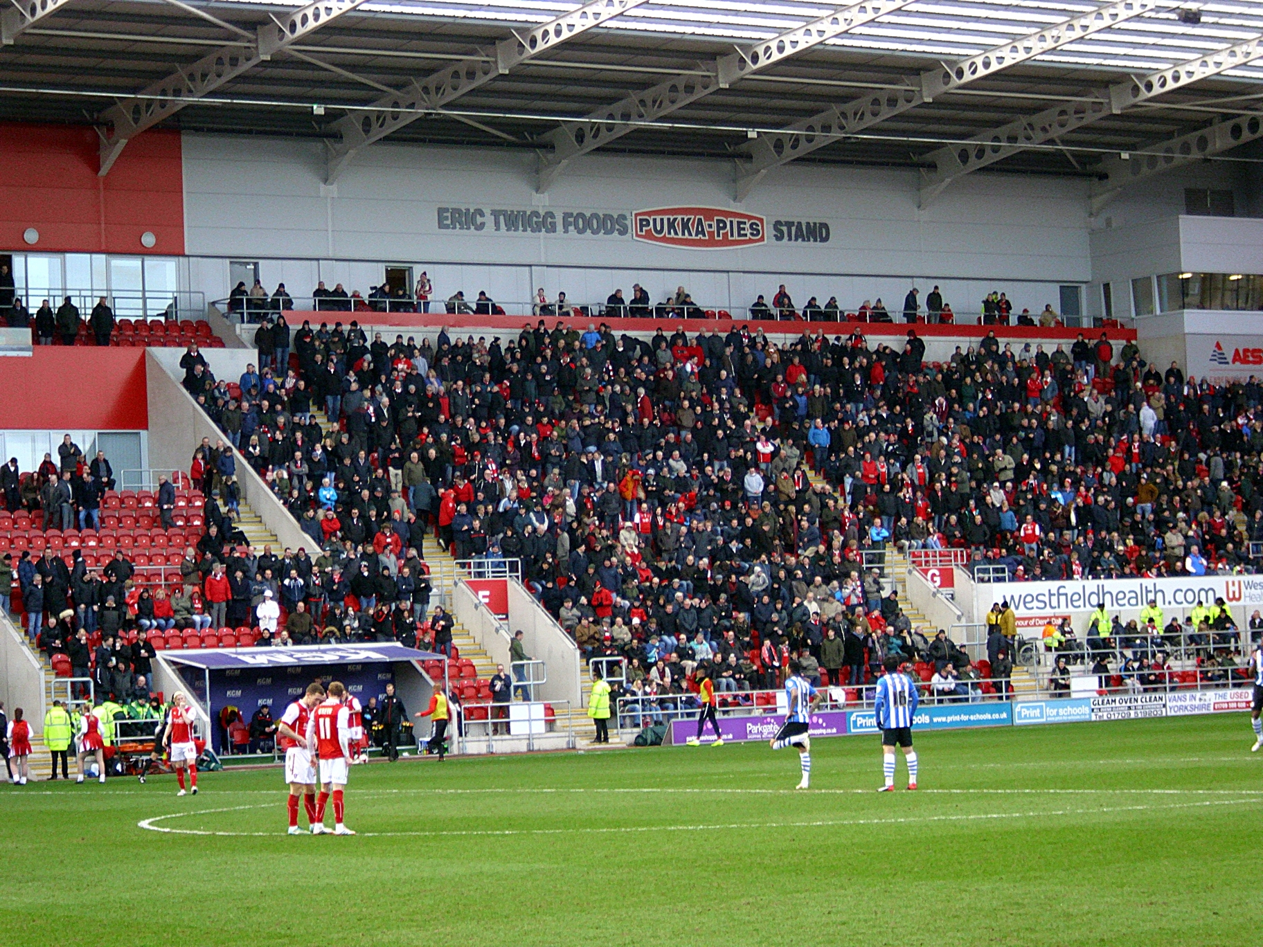 people at a football field in front of an audience watching