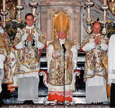 priests at the alter, with a priest holding the cross