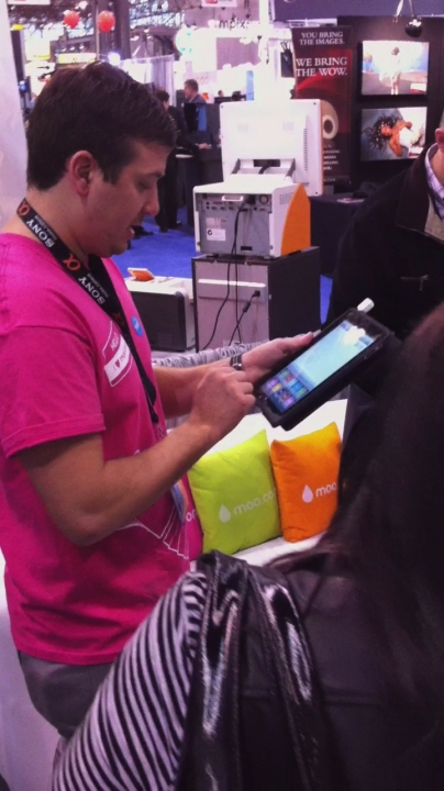 man with a pink shirt working on a mobile device