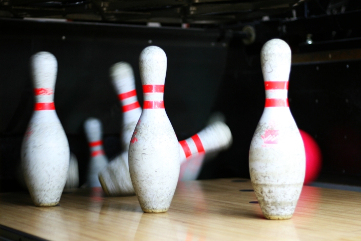 bowling pins lined up with a bowling ball