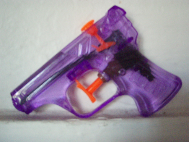 a toy gun with two magnifying heads, is being used as a target for attacking