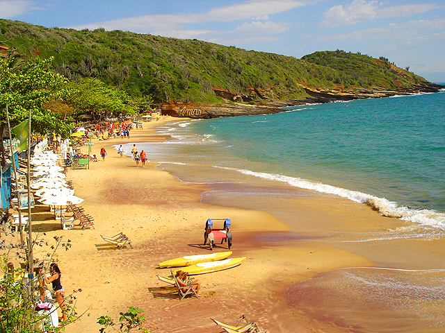 the beach is empty as people walk and sit on chairs