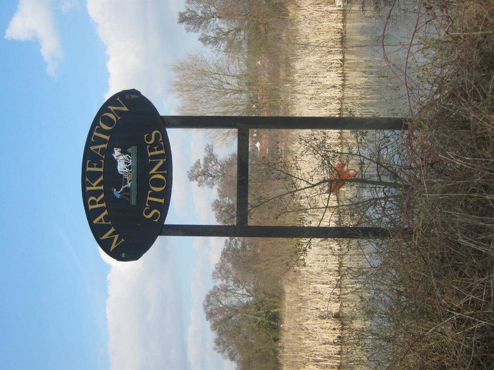 an image of a stone sign in a marsh setting