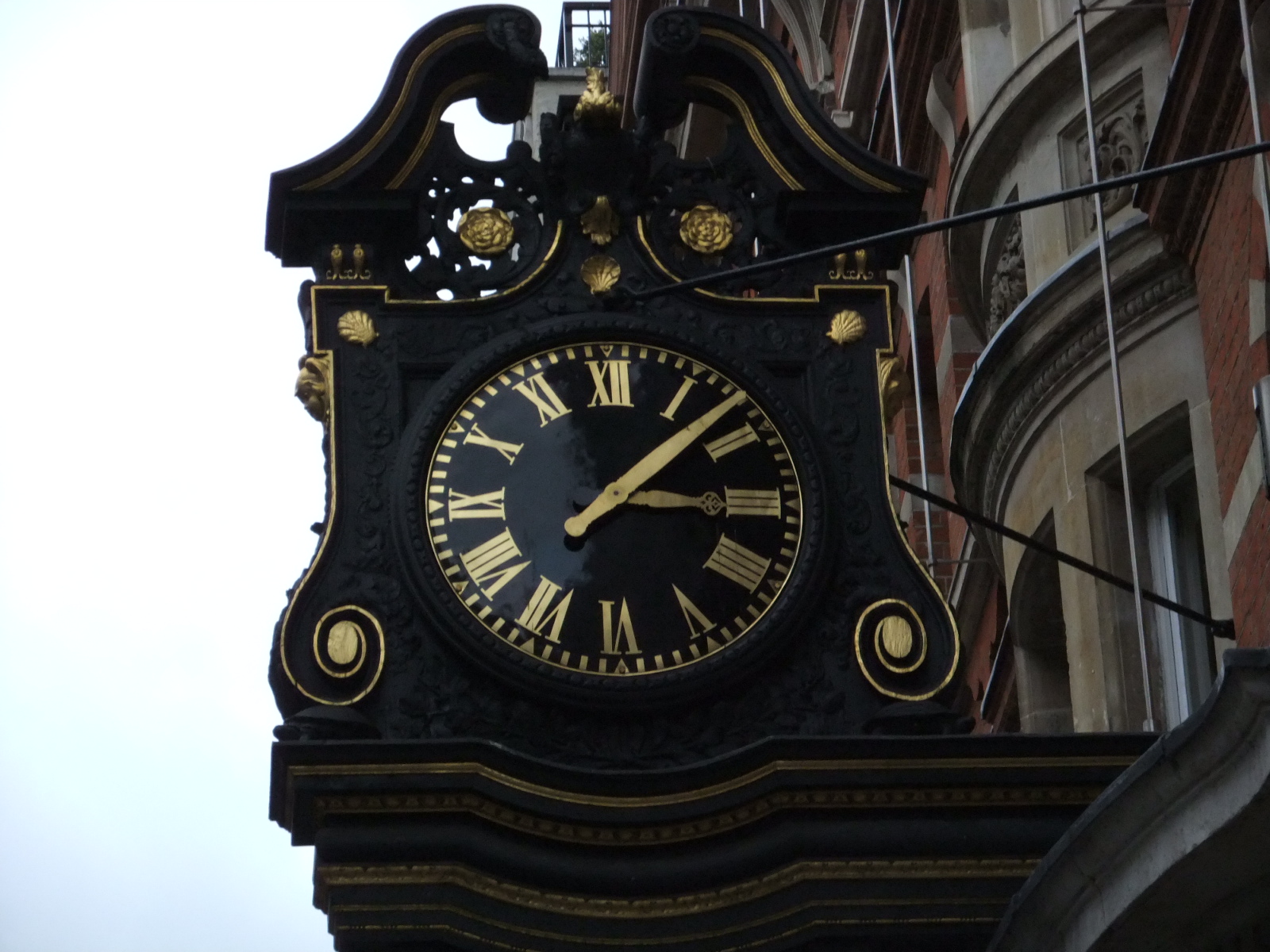 an ornate clock showing 3 55 in the face
