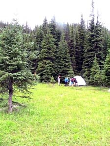 there are several people with tents at the woods