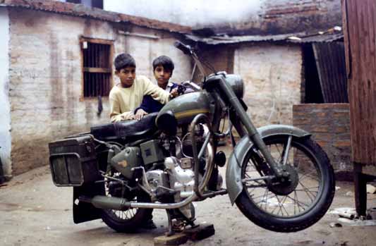 two children sit on the back of a motorcycle