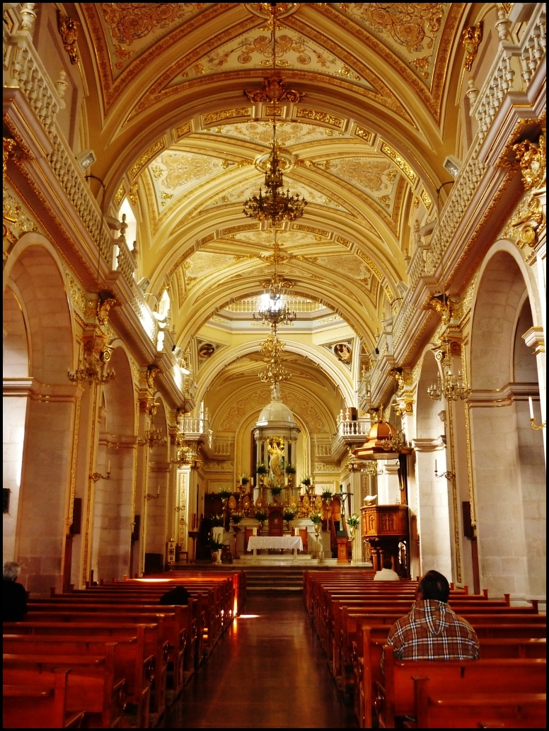 the view from inside a cathedral, where chairs and arches are made