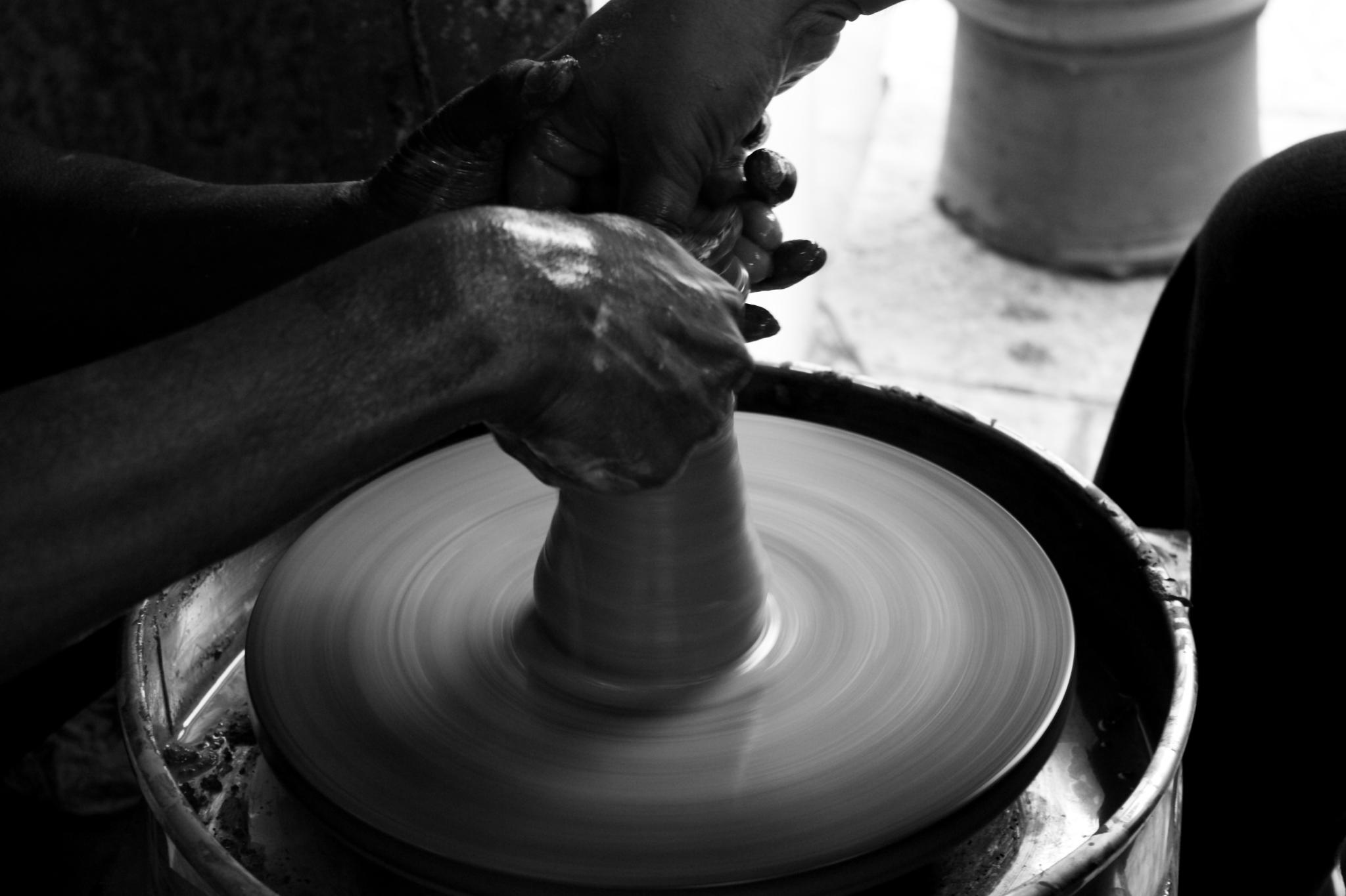 a person working on soing on a potters wheel