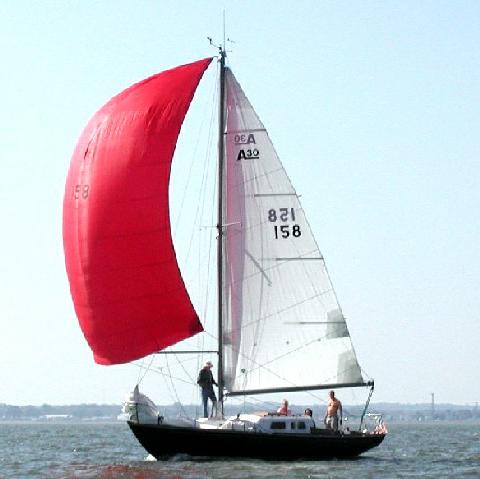 the sail boat is red and white in color
