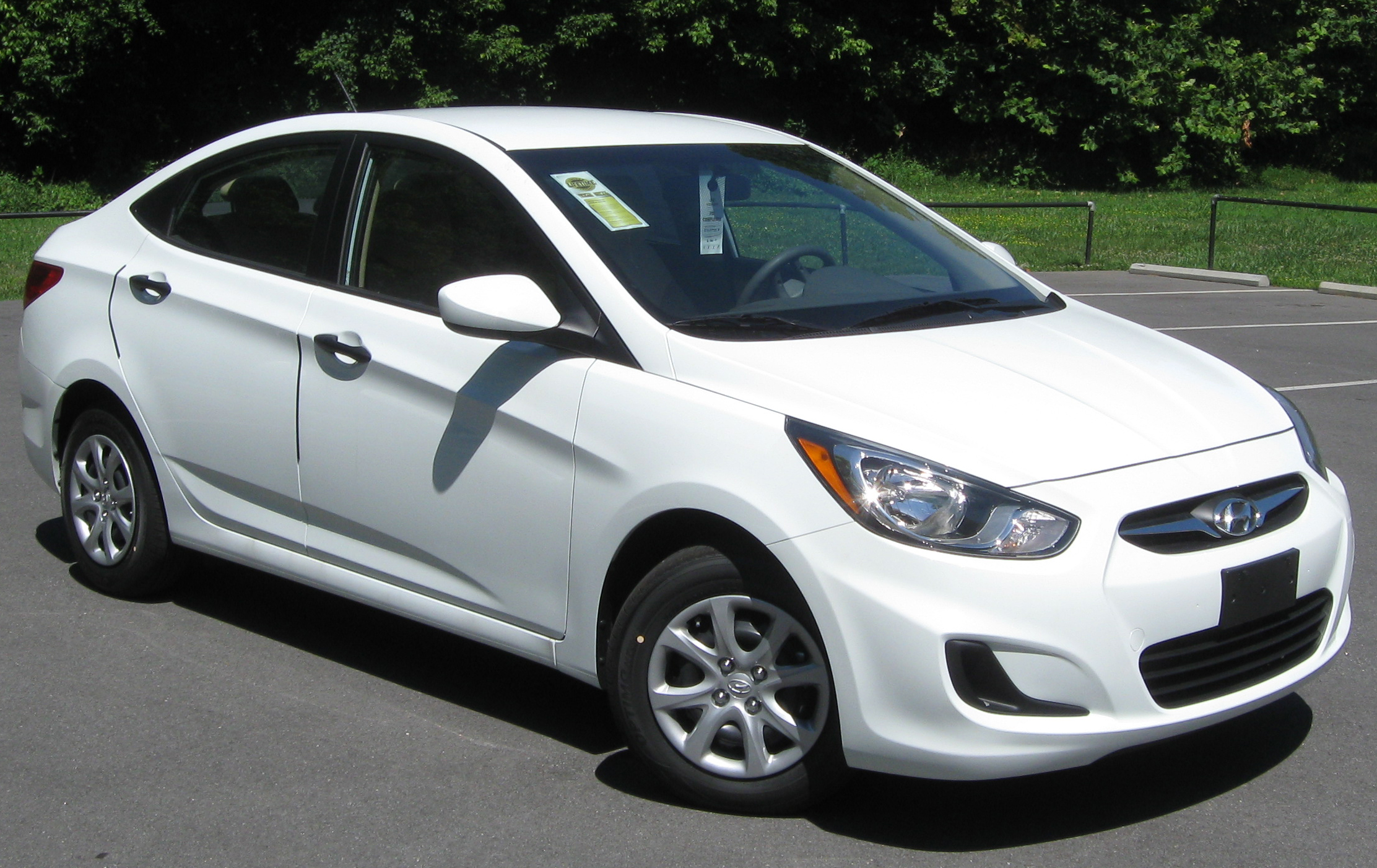 the front view of a white car parked in the lot