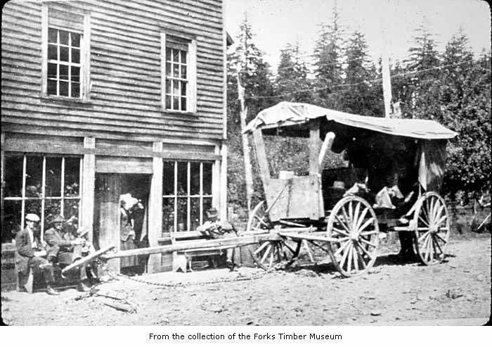 an old picture of people gathered around a small house