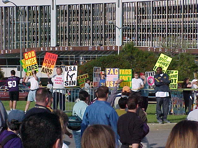people holding up signs in front of an audience