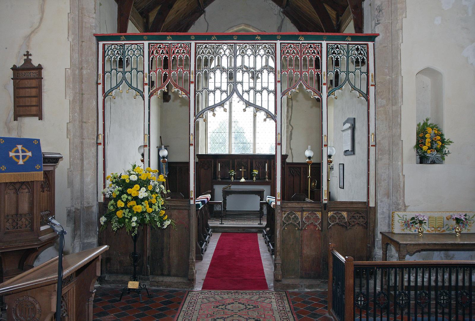 the inside of a church with flowers in the alter