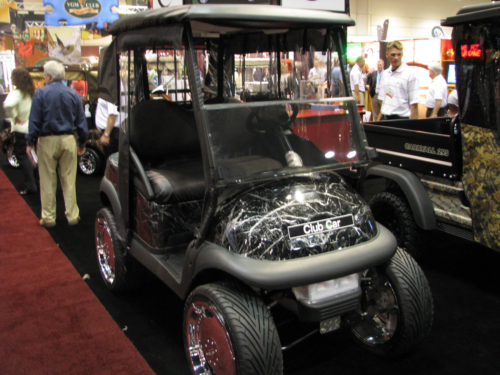 a golf cart is parked on the display floor at an auto show