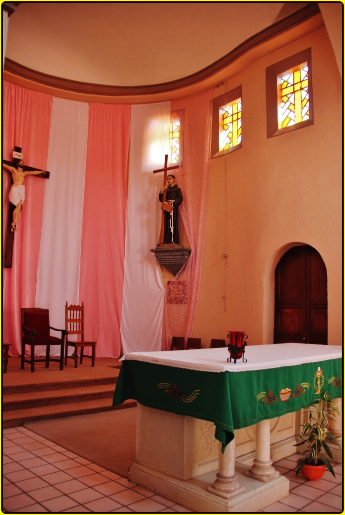 a priest in a church, with a cross