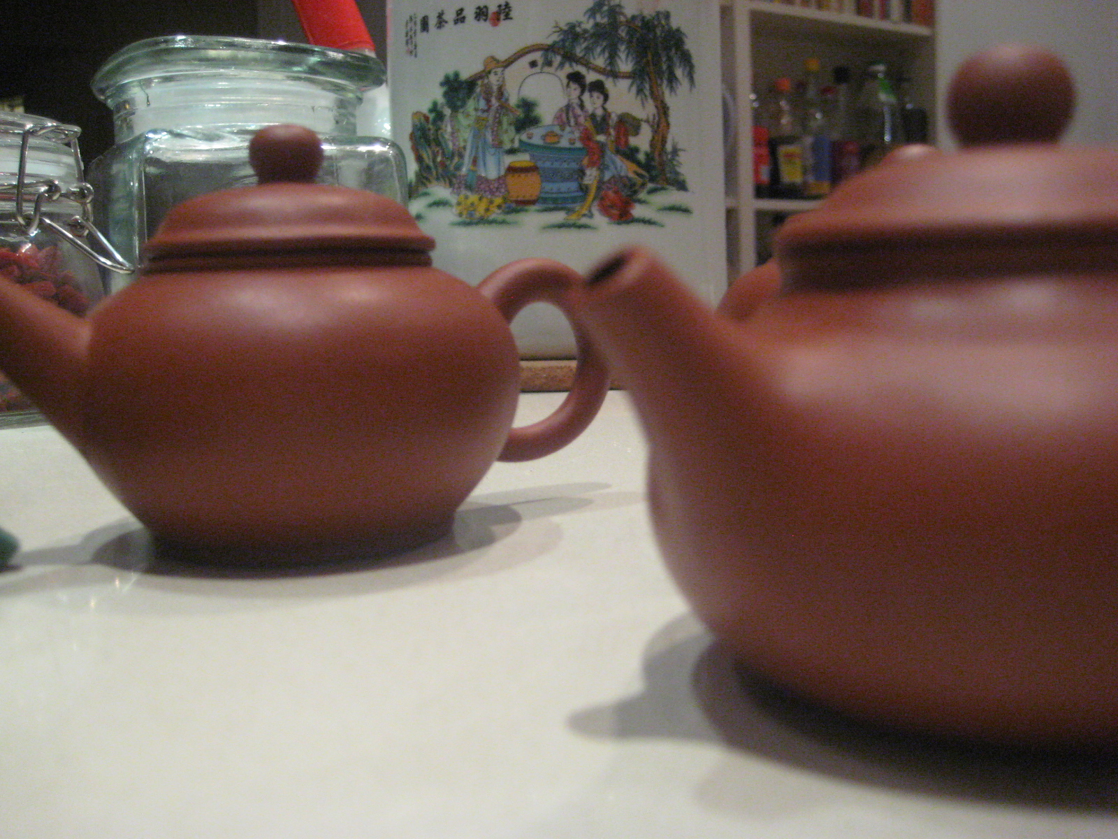 some clay tea pots are sitting on a table