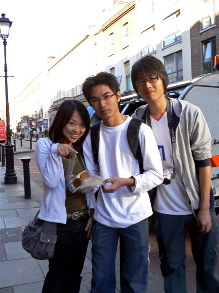 three young friends are standing next to the road