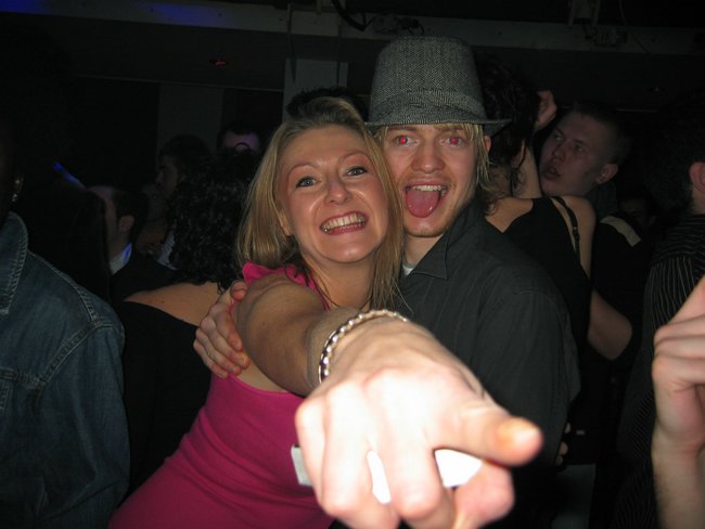 two people posing for the camera at a party