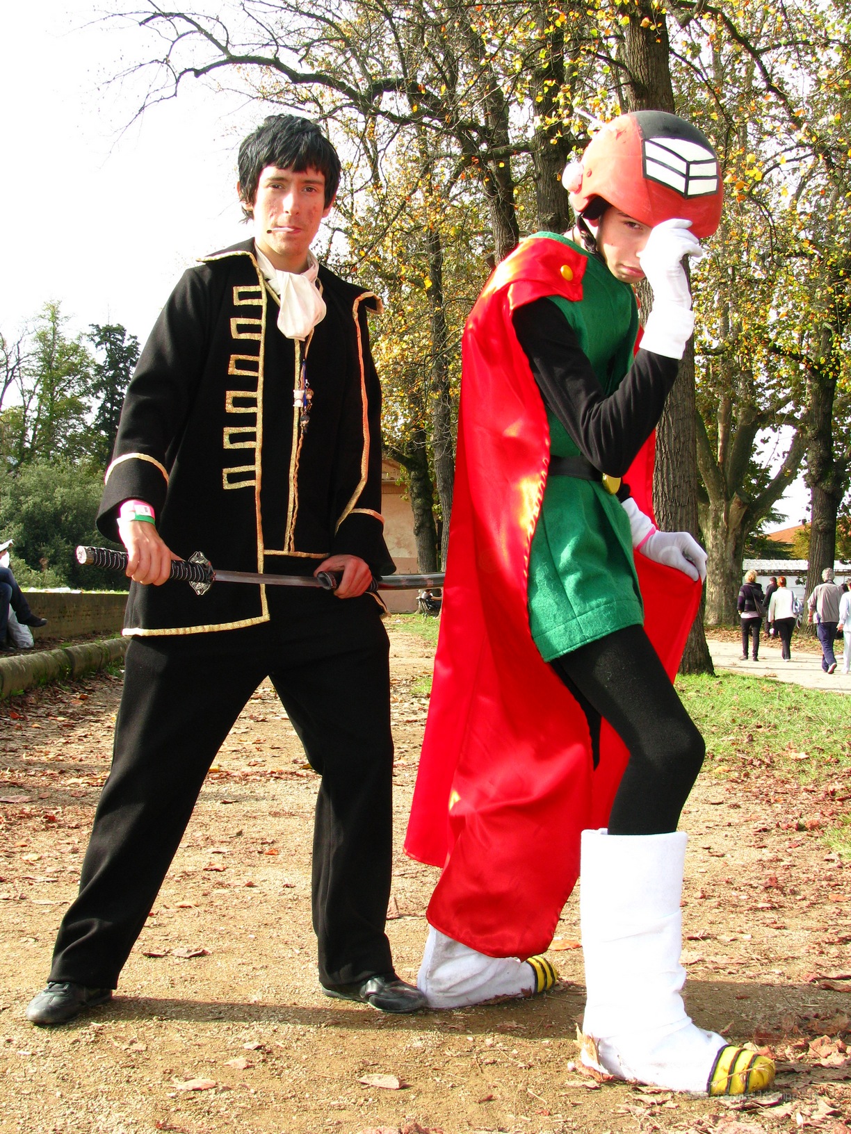 two people dressed up in different outfits in a park