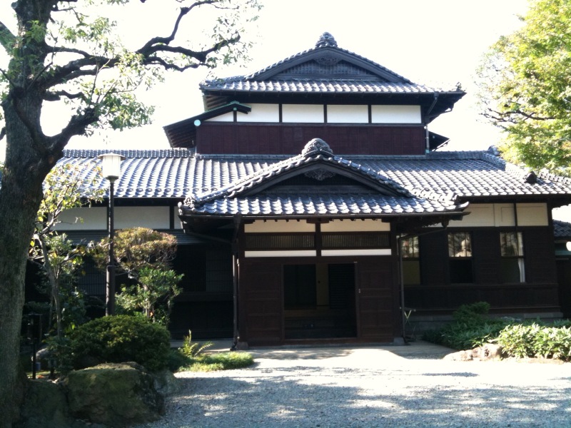 the doorway to an oriental style building in an area surrounded by trees