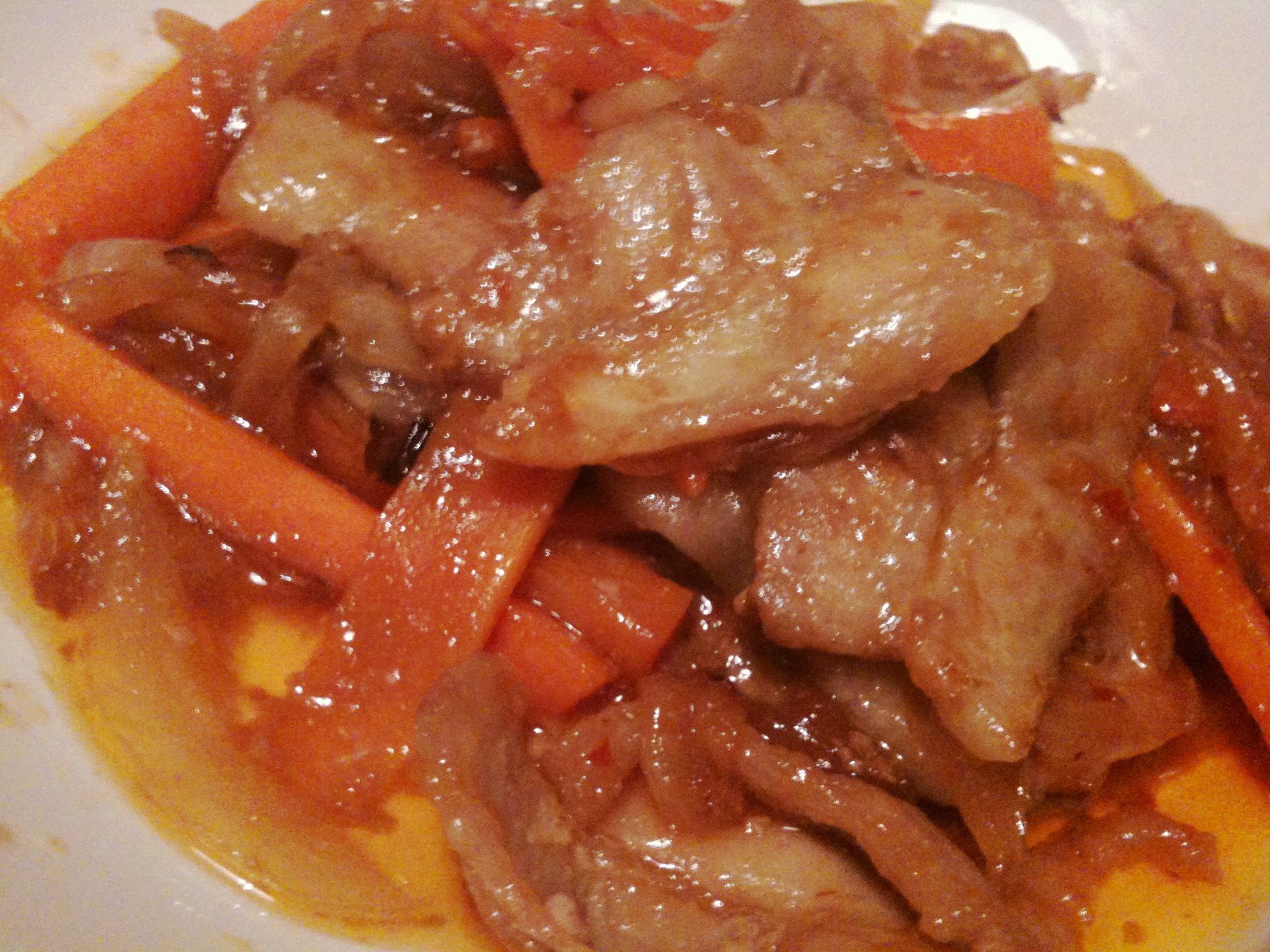 a meal of meat, carrots and gravy on a plate