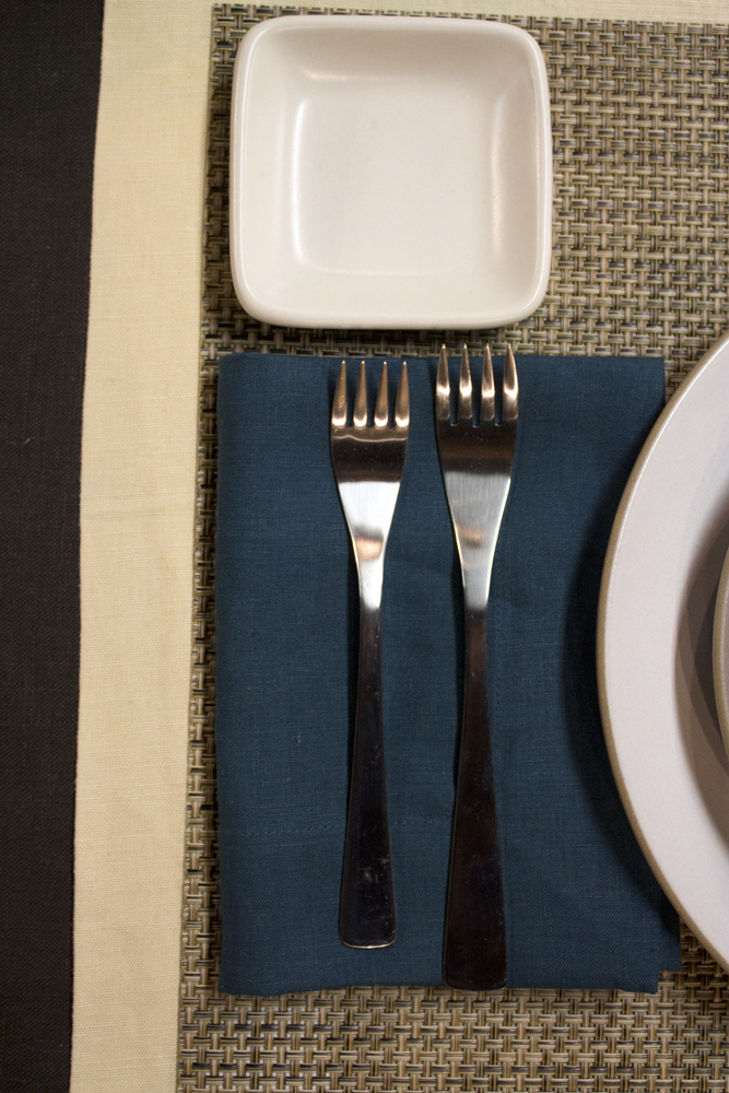 silverware set for a table setting with a plate and napkin