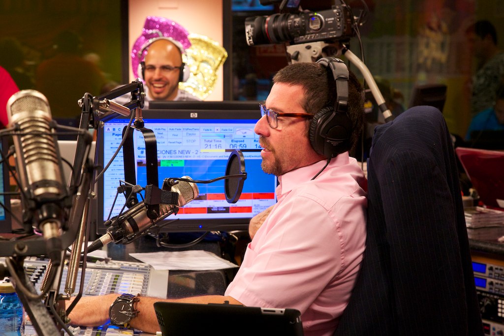 an announcer, a radio host and a tv announcer are on the set