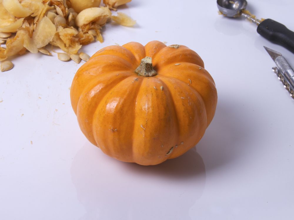 this is a small pumpkin on a white table