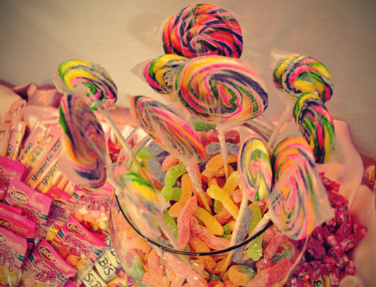 a bowl full of candy and lollipops