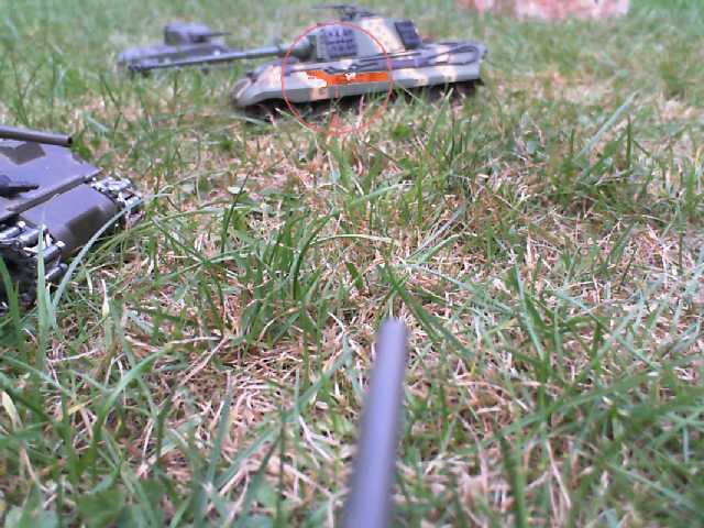a black remote controlled plane lying in the grass
