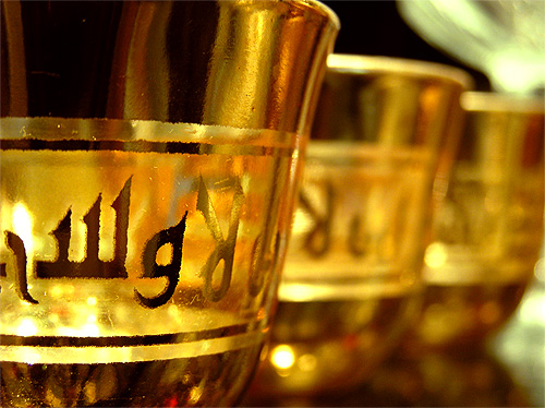 a row of glass cups with writing on the outside